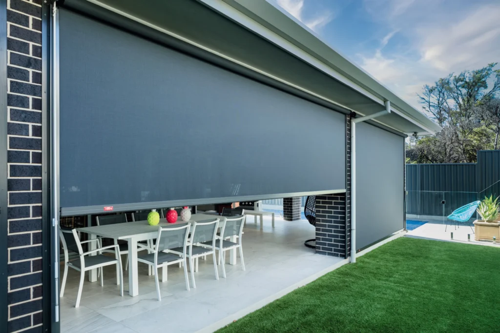 Outdoor blinds installed beside a residential swimming pool.