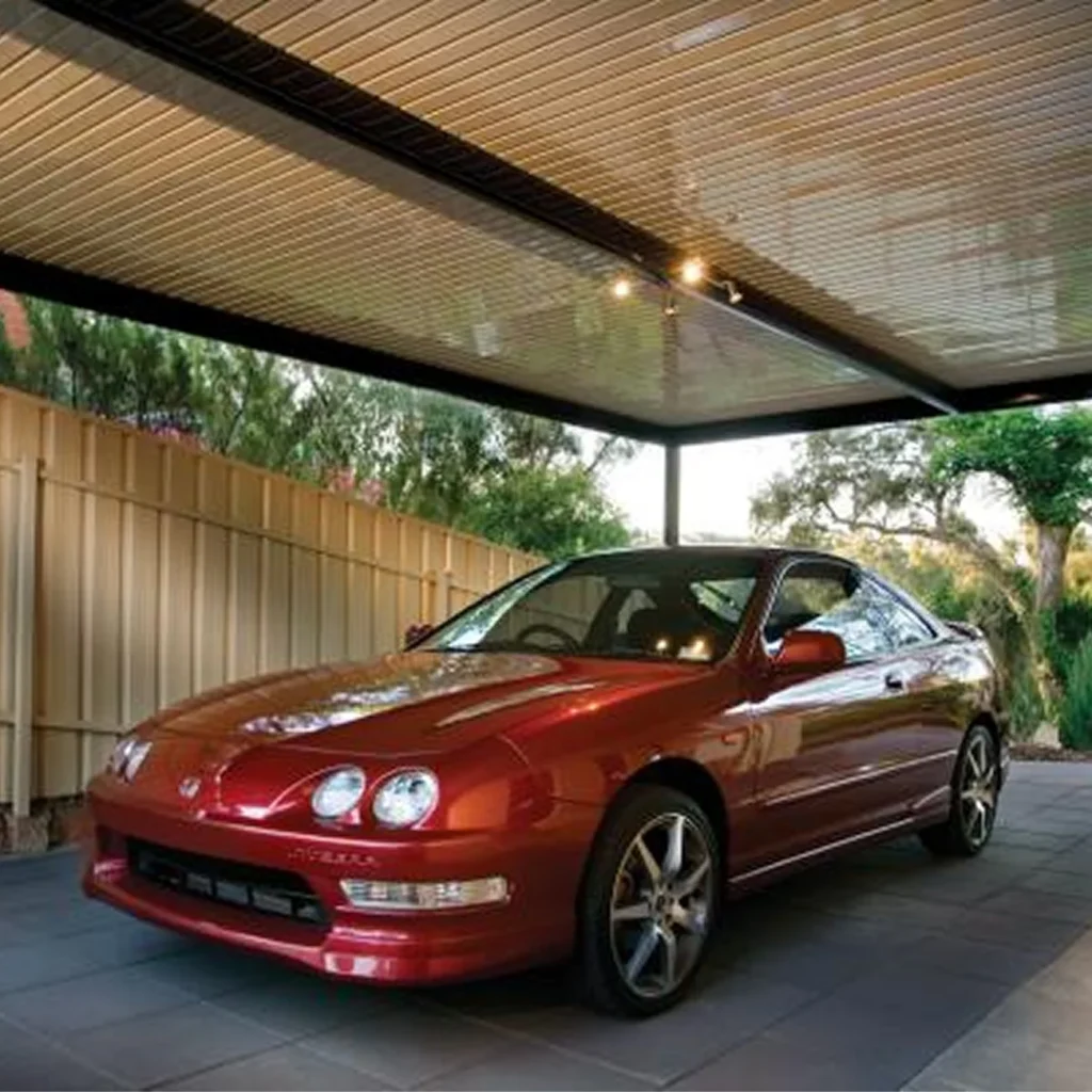 Car cover shade structure installed over a residential driveway.