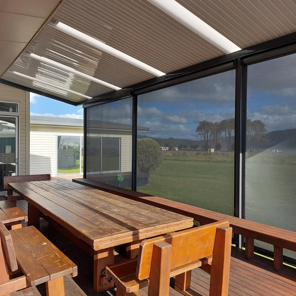 Patio area enclosed with outdoor blinds for added shelter and privacy.